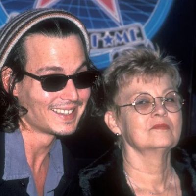 Johnny and Betty are posing as Johnny is wearing a specs and a cap.